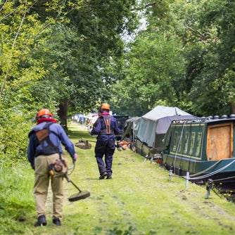 Volunteers mowing on the mooring line